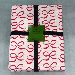 kate spade New York All Wrapped Up tablecloth with a red bow pattern, 60"x84”.